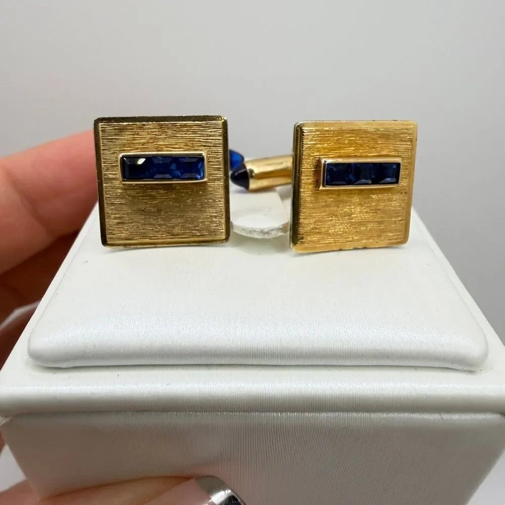 Vintage Krementz Gold tone cuff likes with princess cut blue rhinestone accents!